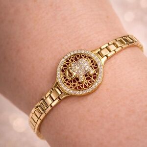 Gold bracelet with mini pave elephant and watchband style band